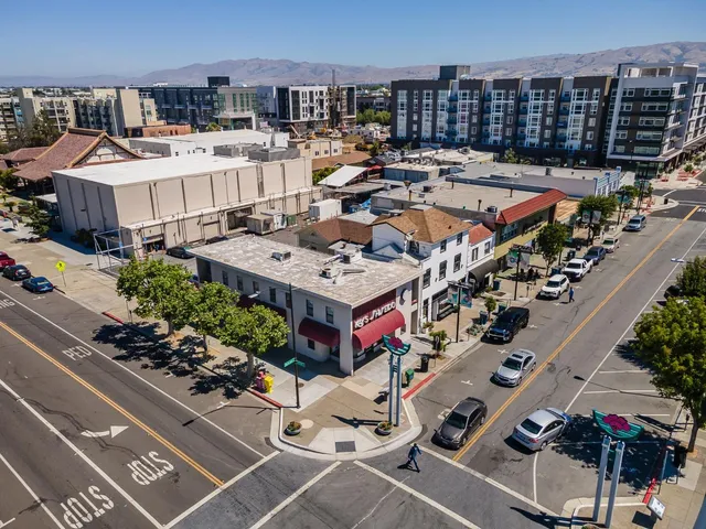 an aerial view of a house with a garden and balcony
