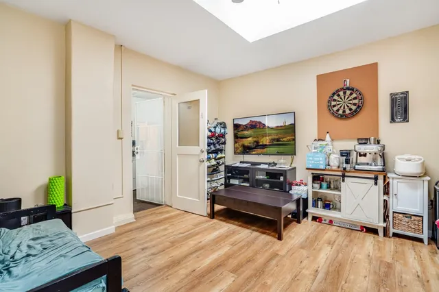 a kitchen with stainless steel appliances a sink and a stove with wooden floor