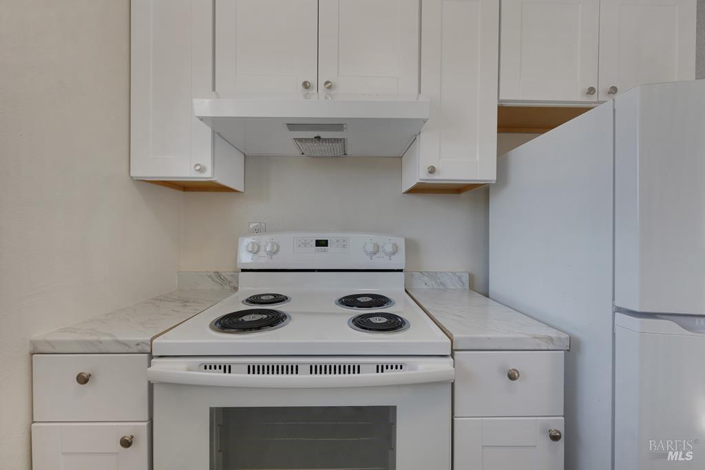 1155-1175 Evans Drive Santa Rosa, CA 95405 - Photo 25 of 31 a kitchen with a stove and white cabinets