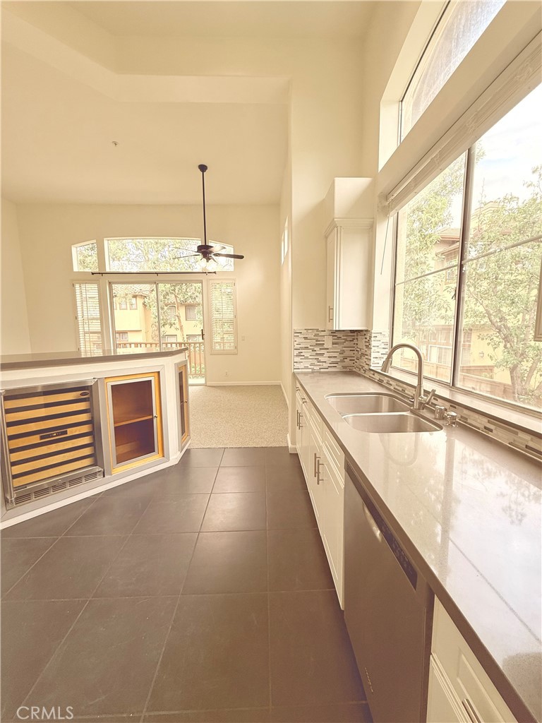 2771 Dunstan Drive Tustin, CA 92782 - Photo 19 of 39 a large kitchen with granite countertop a large window and a sink