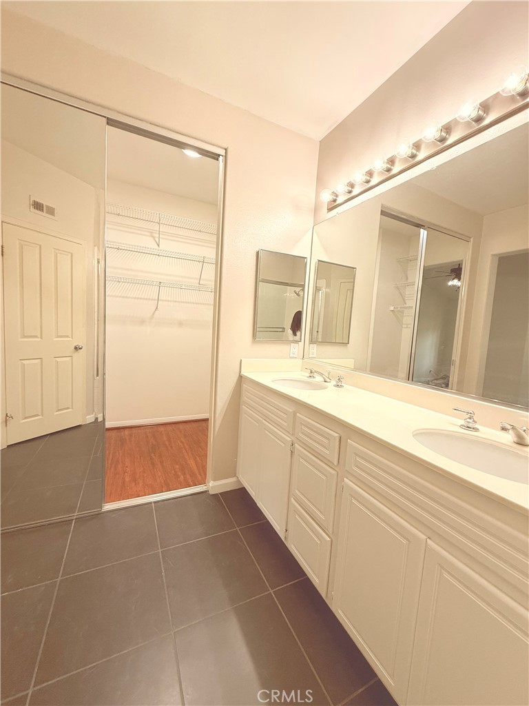 2771 Dunstan Drive Tustin, CA 92782 - Photo 28 of 39 a bathroom with a shower sink and mirror