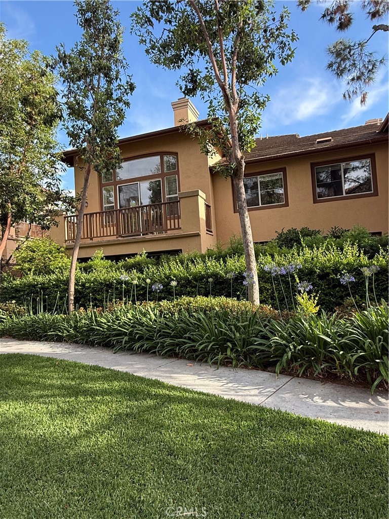 2771 Dunstan Drive Tustin, CA 92782 - Photo 3 of 39 a front view of a house with a garden and plants
