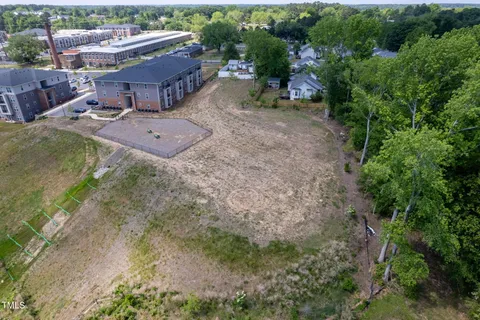 an aerial view of a house with yard