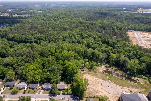 an aerial view of a house with a yard and lake view