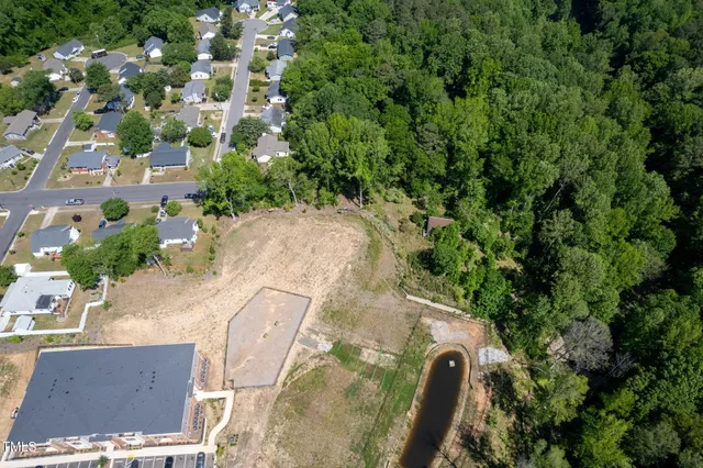 an aerial view of a house with a yard and sitting area