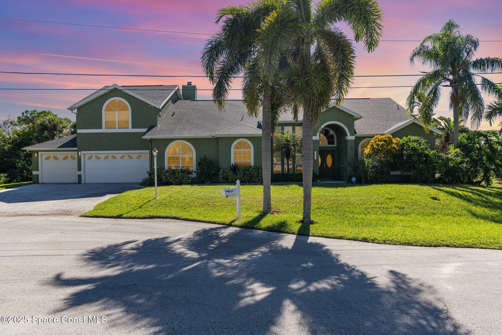 a front view of house with yard and green space