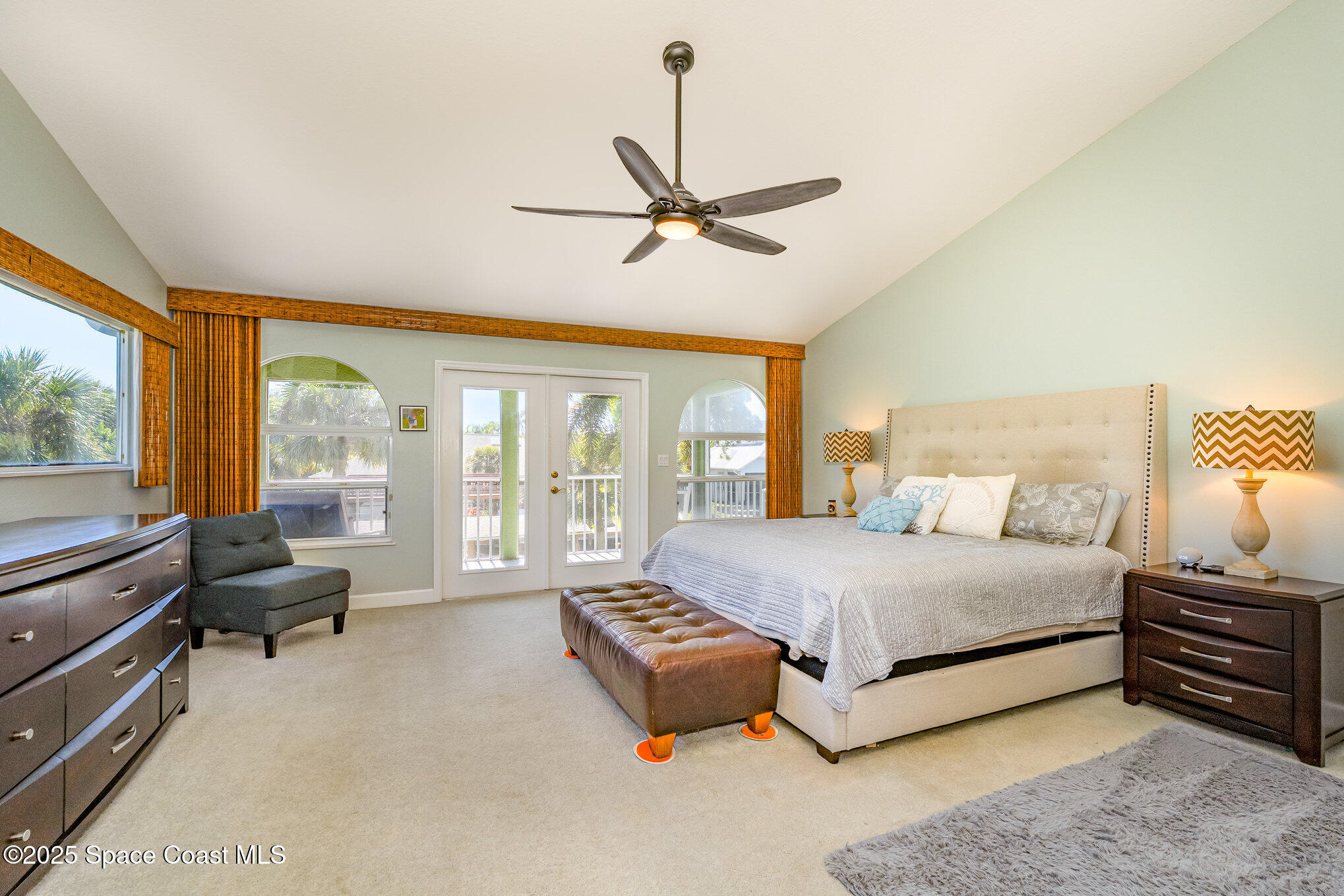 1617 Sun Point Place Merritt Island, FL 32952 - Photo 19 of 42 a spacious bedroom with a bed couch and large window
