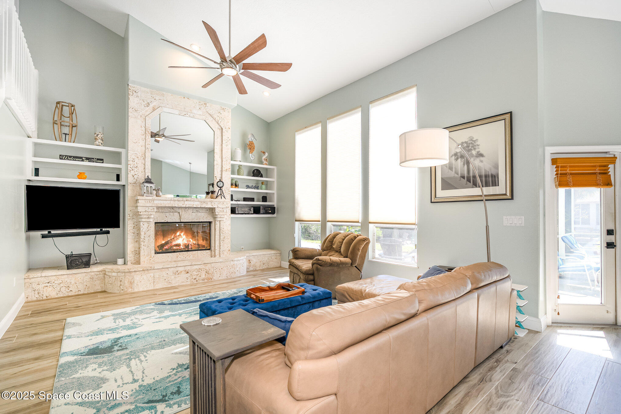 1617 Sun Point Place Merritt Island, FL 32952 - Photo 2 of 42 a living room with furniture and a flat screen tv