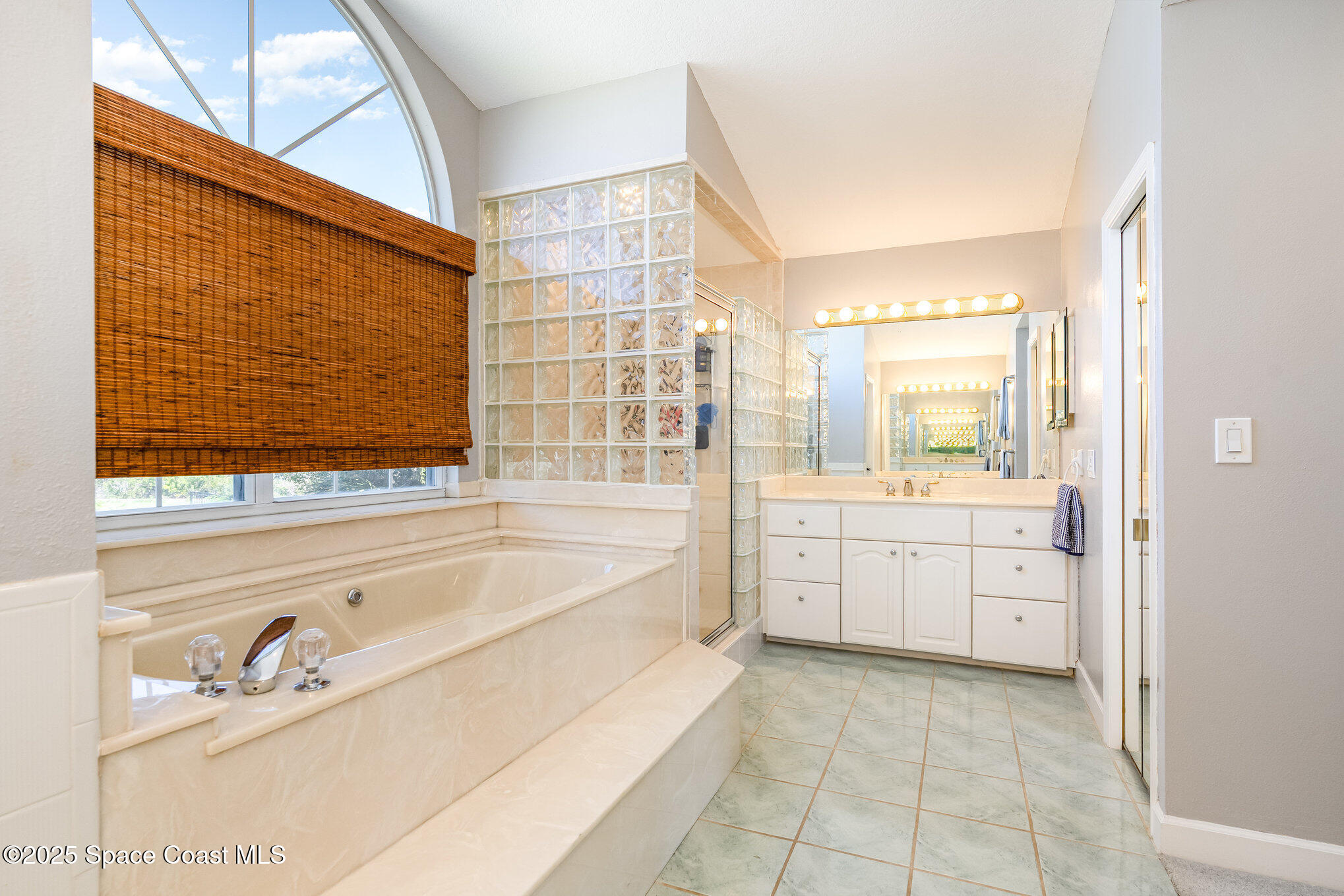 1617 Sun Point Place Merritt Island, FL 32952 - Photo 21 of 42 a spacious bathroom with a tub sink shower and mirror