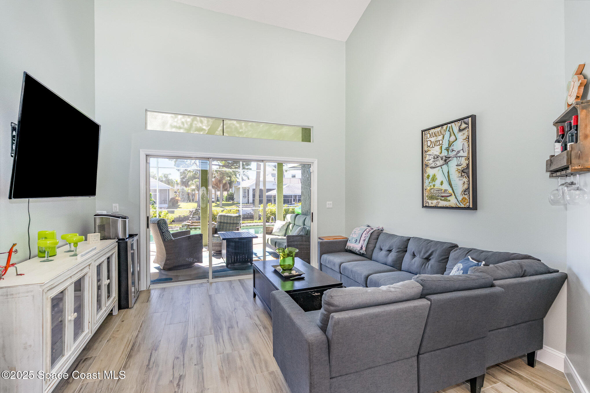 1617 Sun Point Place Merritt Island, FL 32952 - Photo 24 of 42 a living room with furniture and a flat screen tv