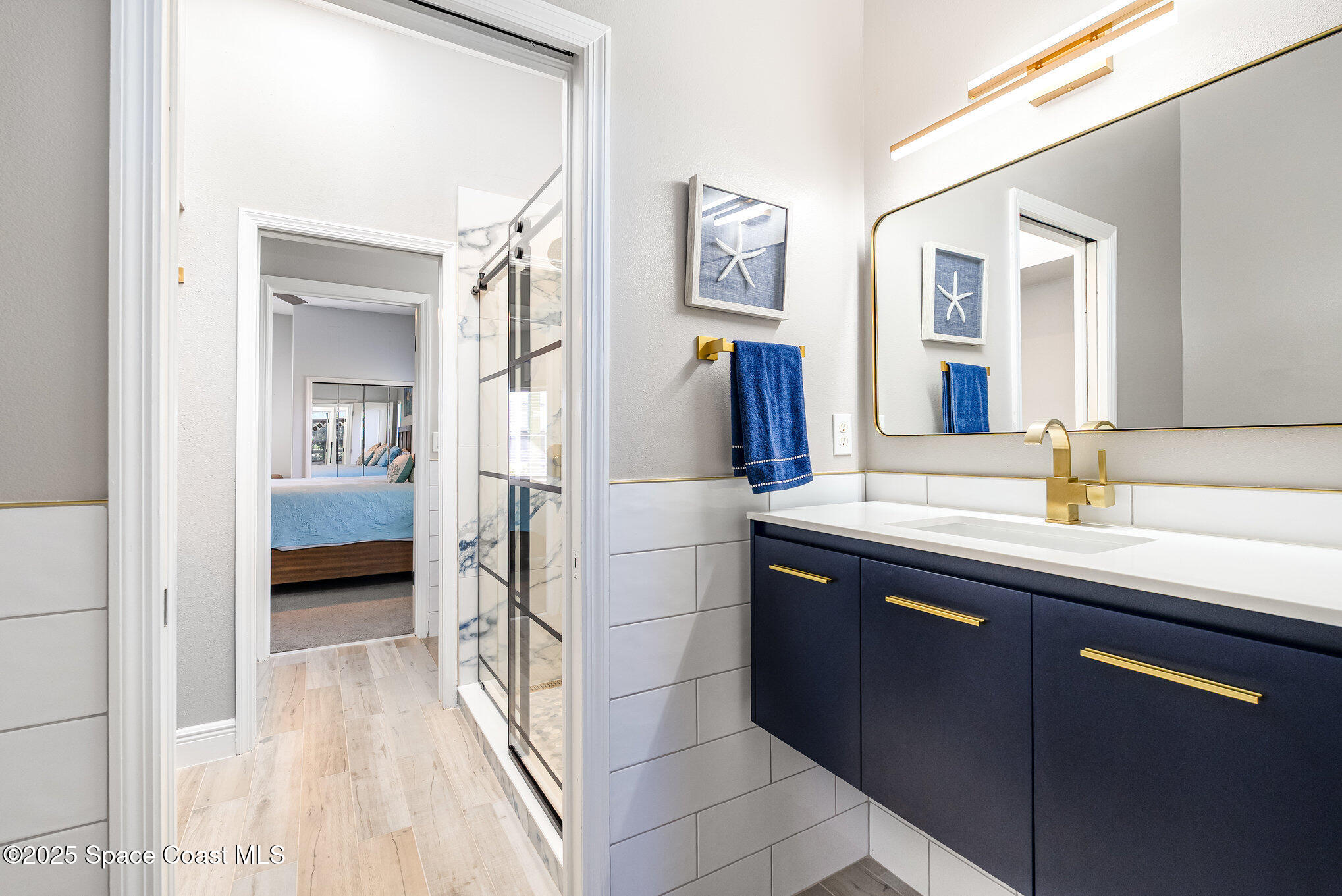 1617 Sun Point Place Merritt Island, FL 32952 - Photo 26 of 42 a en suite bathroom with a sink and a mirror