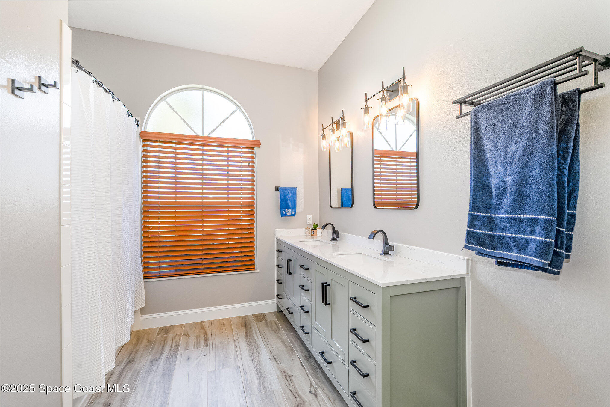 1617 Sun Point Place Merritt Island, FL 32952 - Photo 28 of 42 a bathroom with a sink and a mirror
