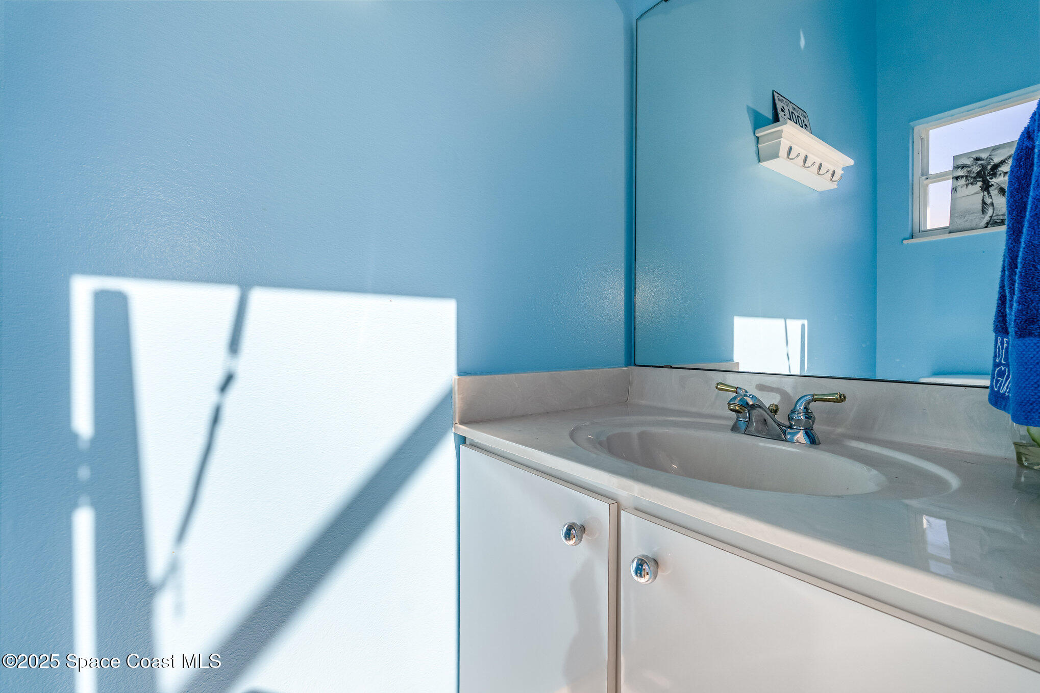 1617 Sun Point Place Merritt Island, FL 32952 - Photo 32 of 42 a bathroom with a sink and a mirror