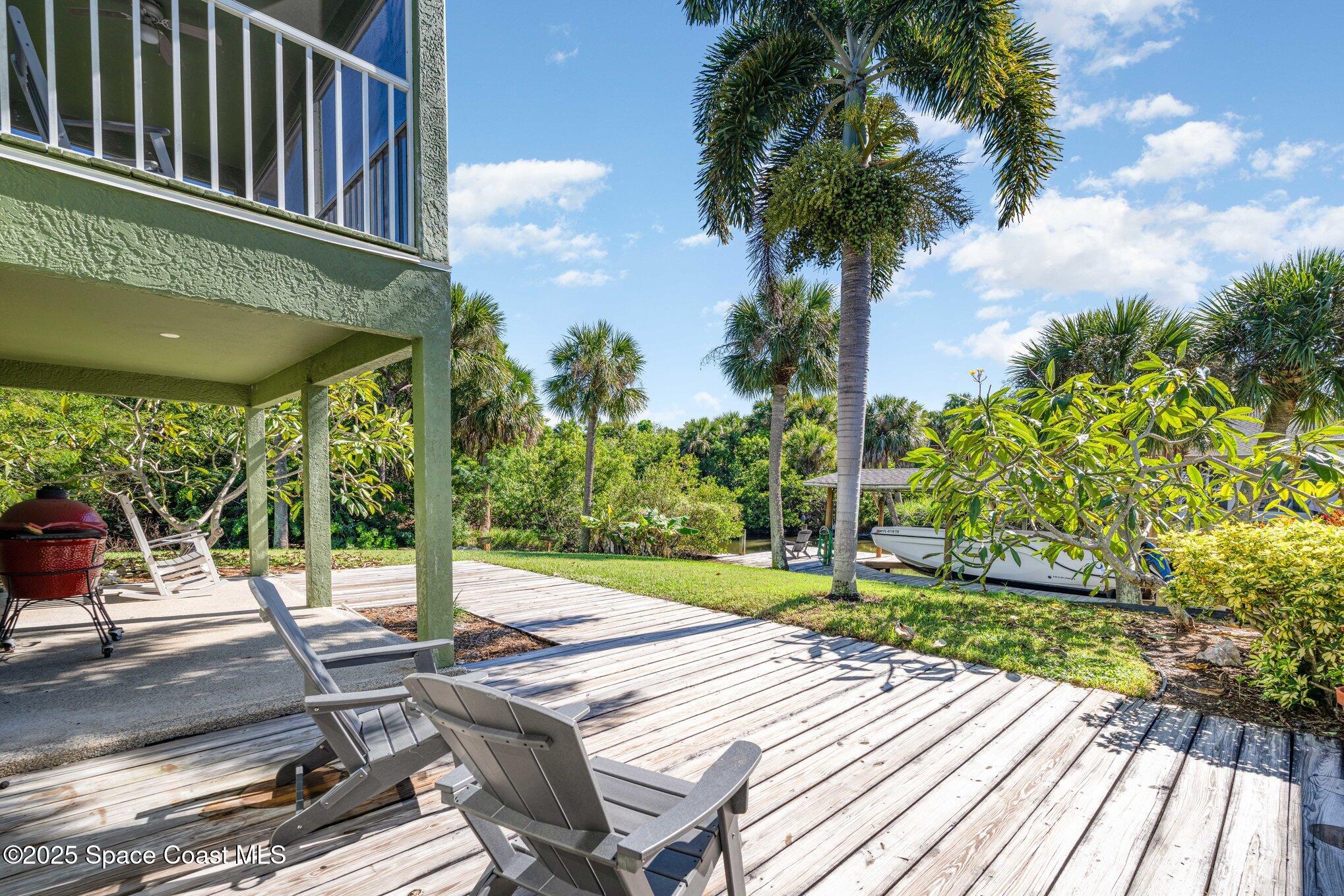 1617 Sun Point Place Merritt Island, FL 32952 - Photo 34 of 42 a view of a patio with a table chairs and a patio