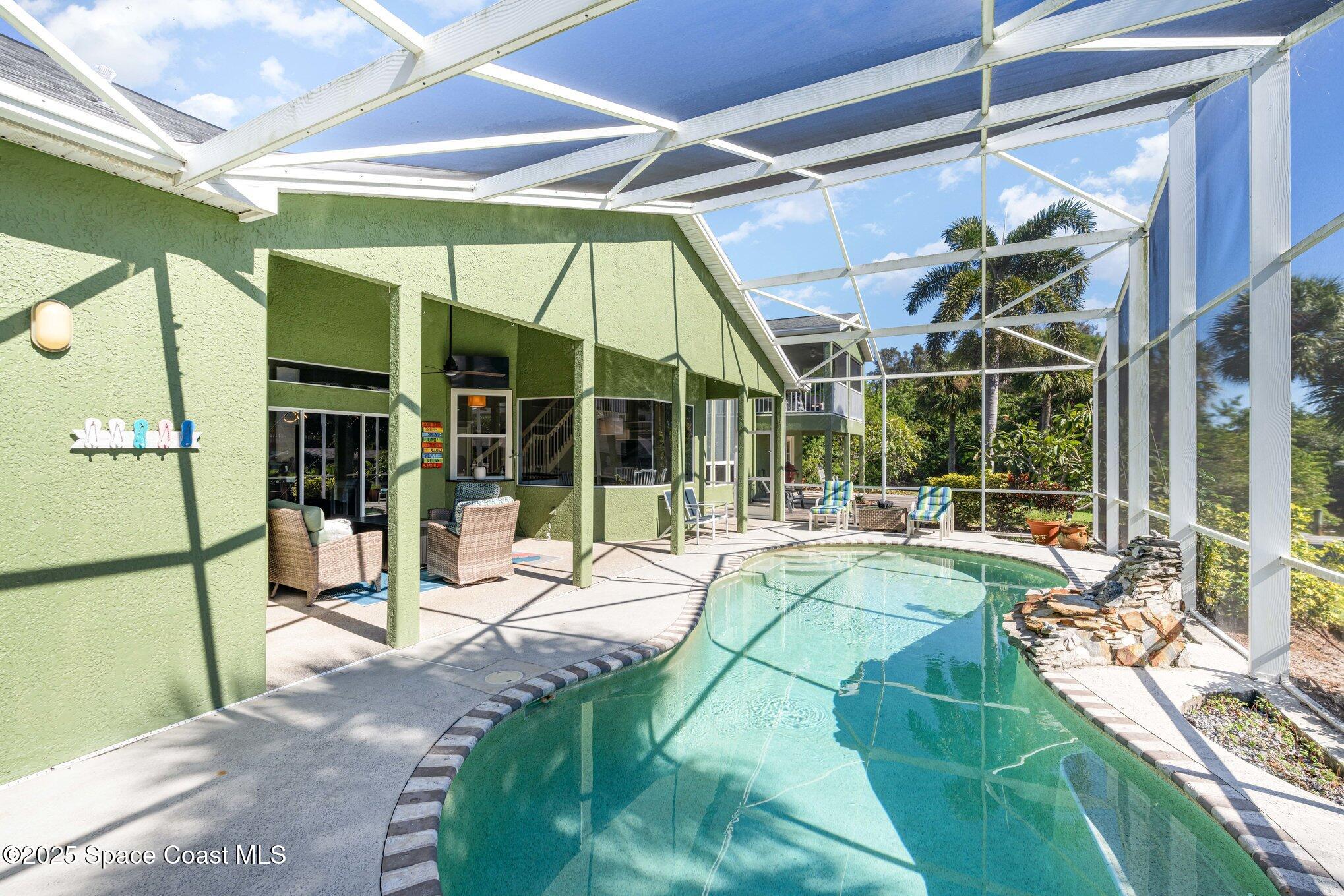1617 Sun Point Place Merritt Island, FL 32952 - Photo 35 of 42 a view of a house with a backyard porch and sitting area