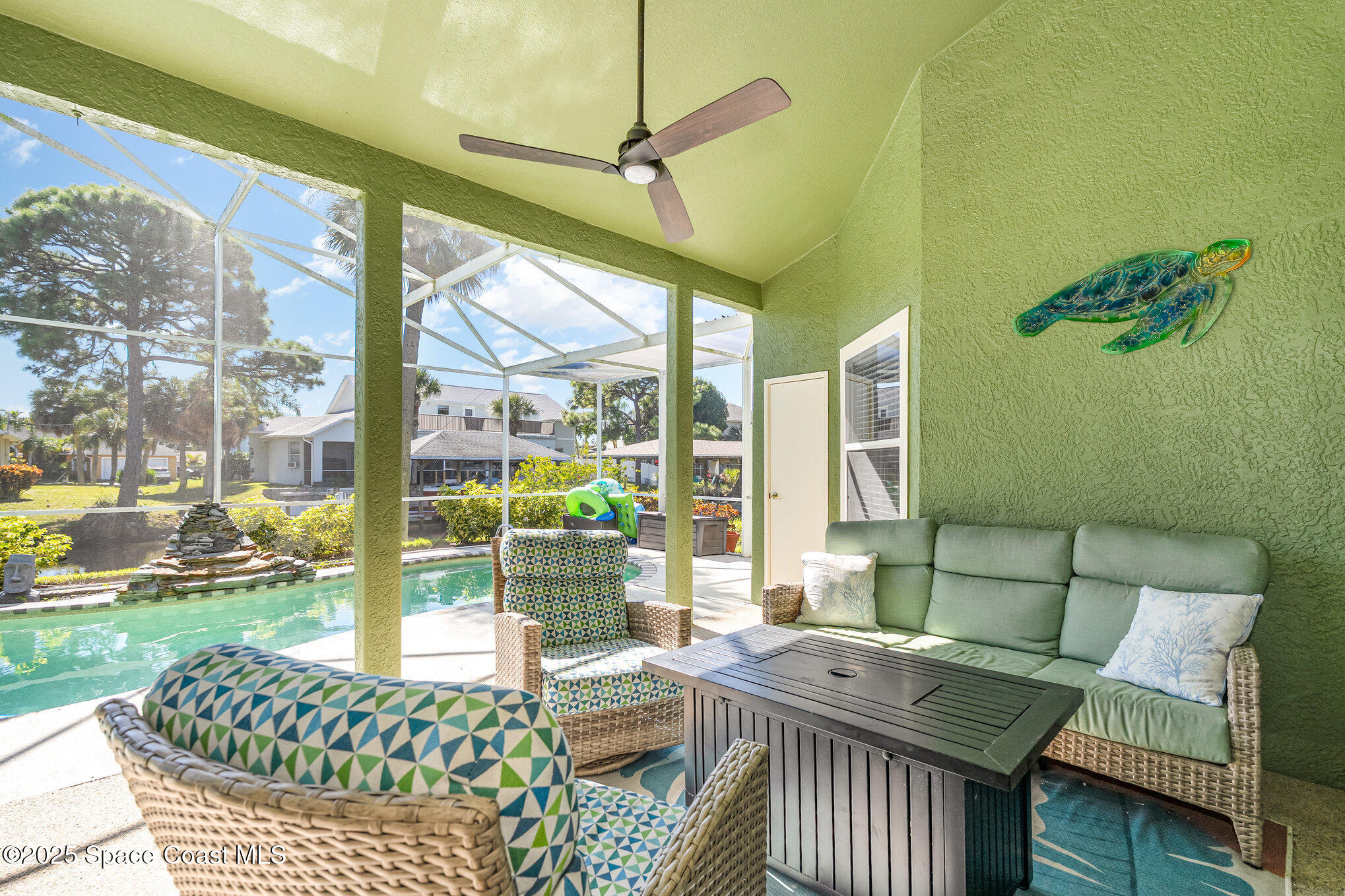 1617 Sun Point Place Merritt Island, FL 32952 - Photo 36 of 42 a living room with furniture and a floor to ceiling window