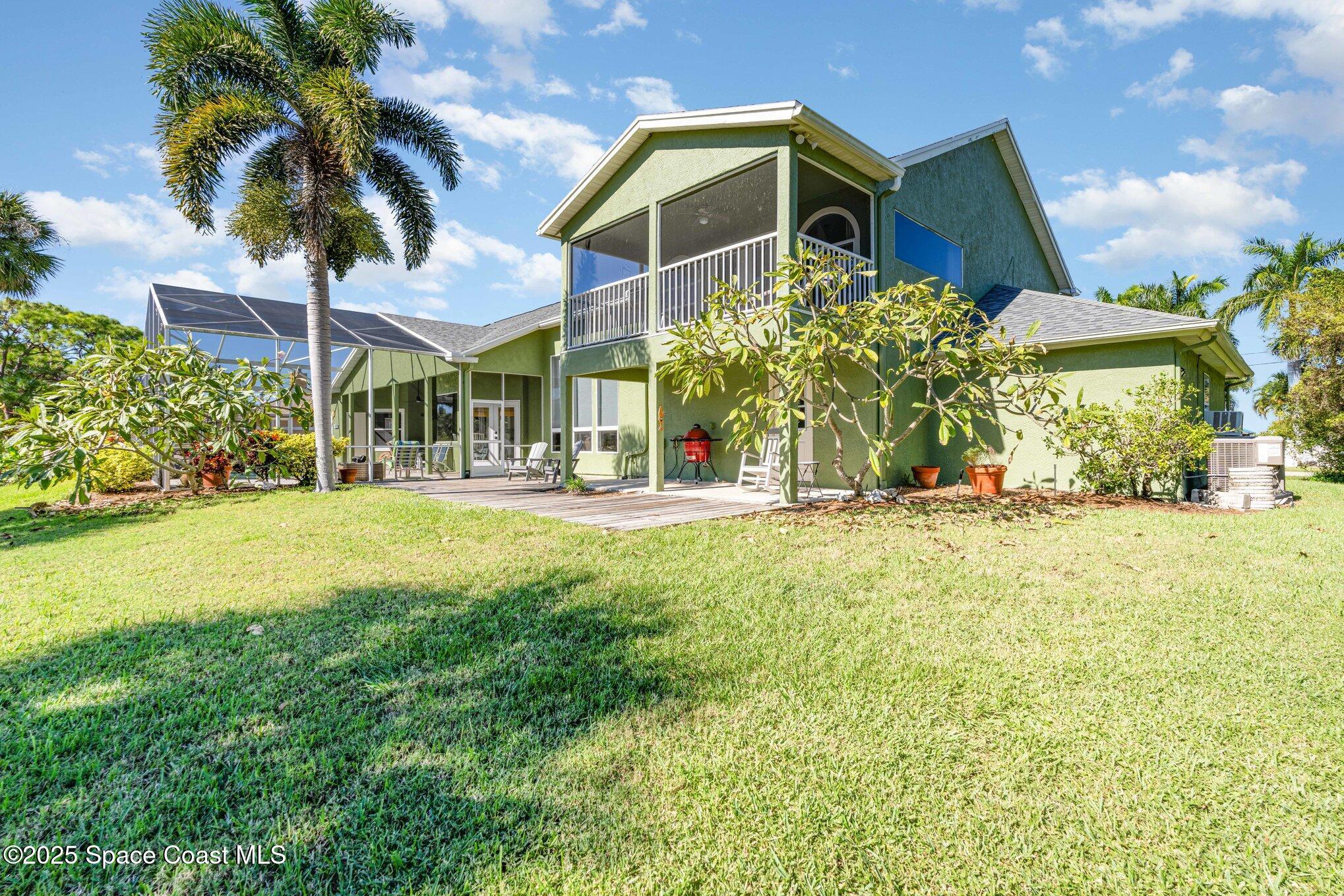 1617 Sun Point Place Merritt Island, FL 32952 - Photo 37 of 42 a front view of a house with a yard