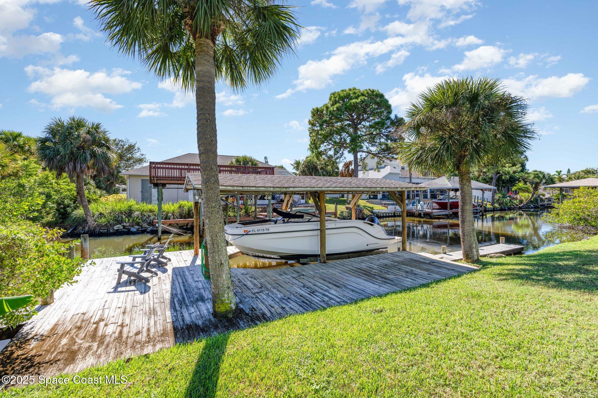 1617 Sun Point Place Merritt Island, FL 32952 - Photo 38 of 42 a view of a swimming pool with a patio and a garden