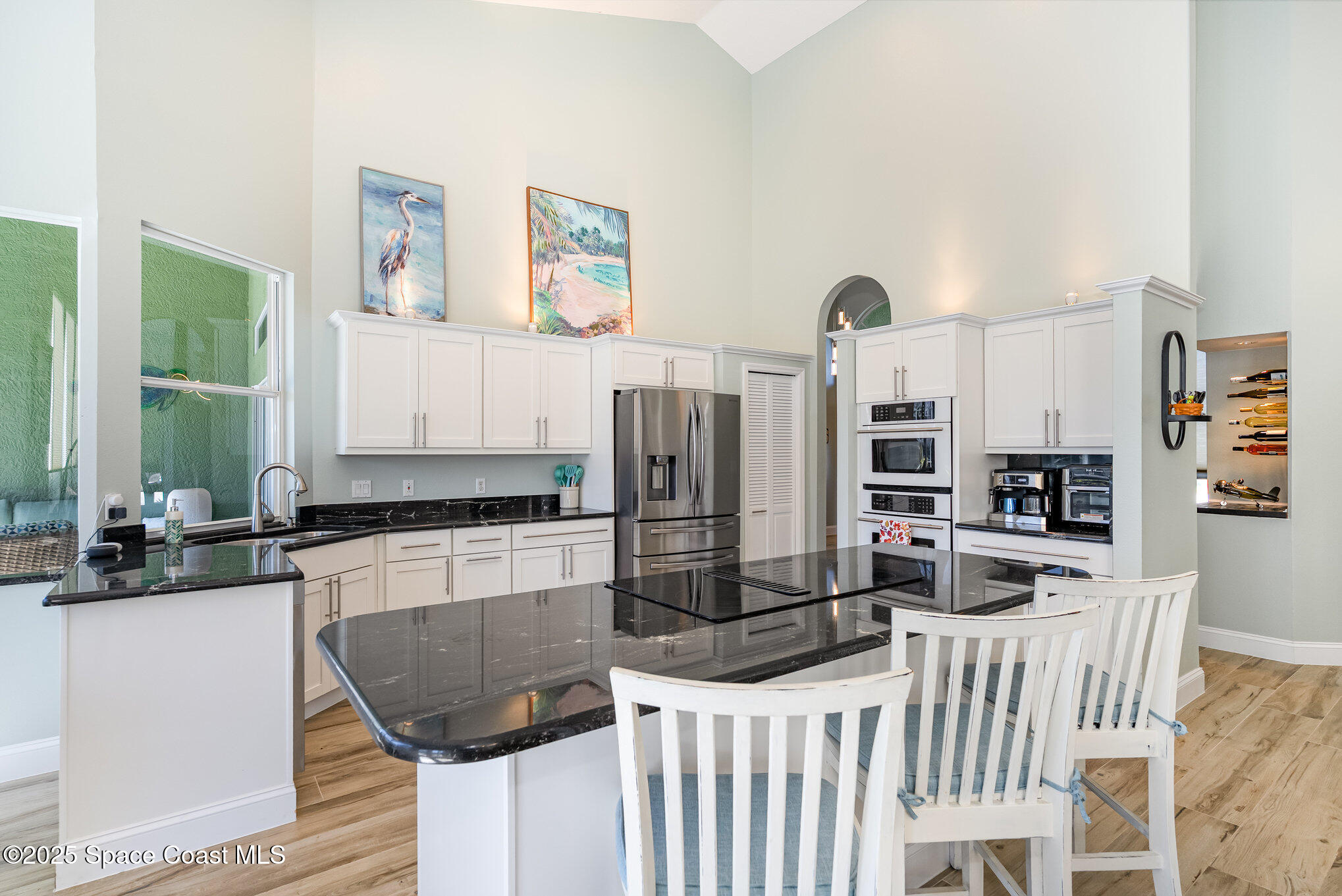 1617 Sun Point Place Merritt Island, FL 32952 - Photo 4 of 42 a kitchen with stainless steel appliances kitchen island granite countertop a refrigerator and microwave