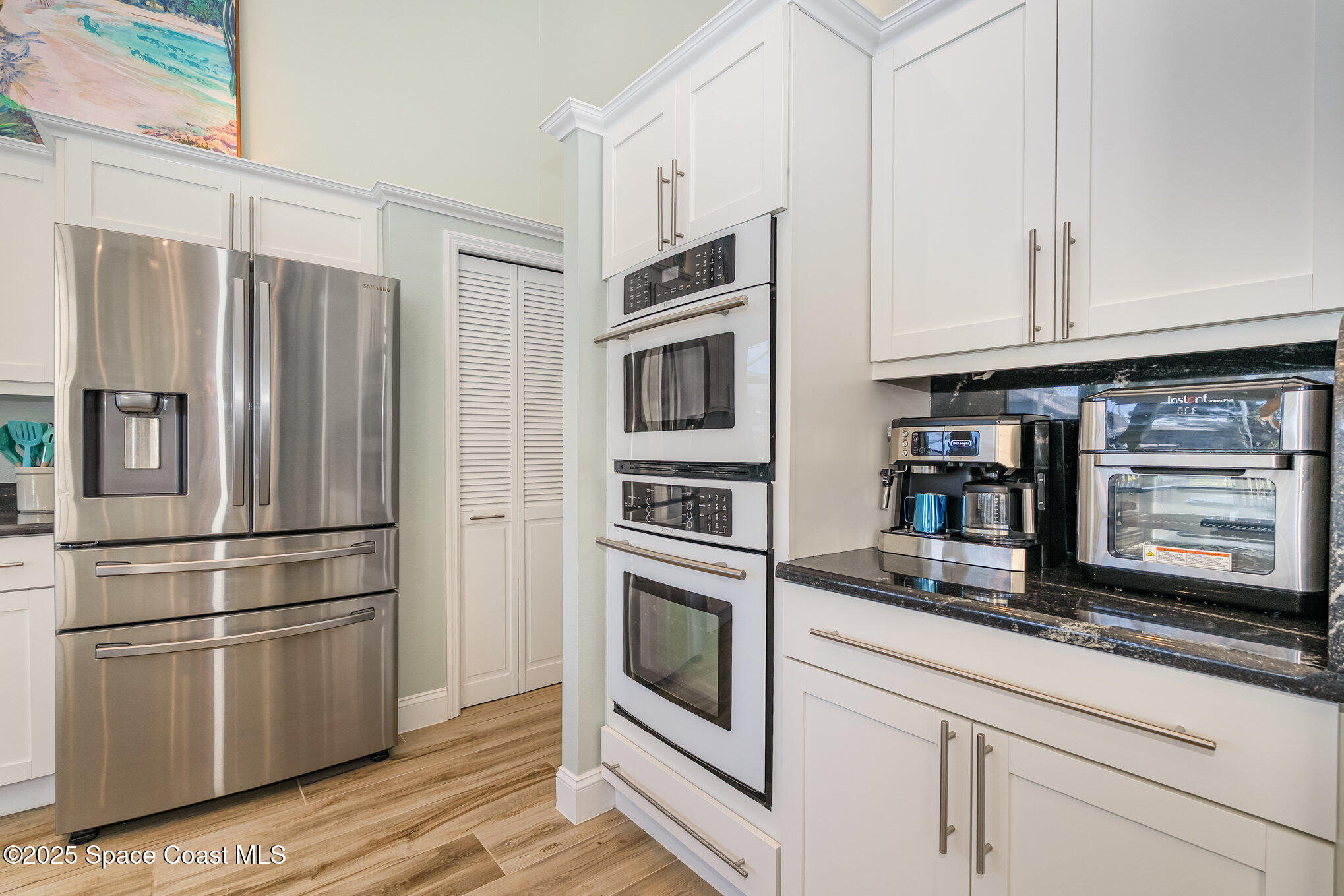 1617 Sun Point Place Merritt Island, FL 32952 - Photo 8 of 42 a kitchen with stainless steel appliances and white cabinets