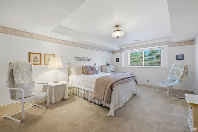 3766 Cardiff Circle Bountiful, UT 84010 - Photo 24 of 46 Carpeted room featuring a white ceiling with a decorative drop, a single window with horizontal blinds, and a ceiling-mounted light fixture