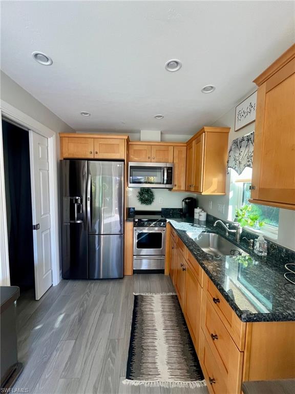 5003 Coach Lane Naples, FL 34114 - Photo 12 of 17 a large kitchen with stainless steel appliances granite countertop a stove refrigerator and a sink
