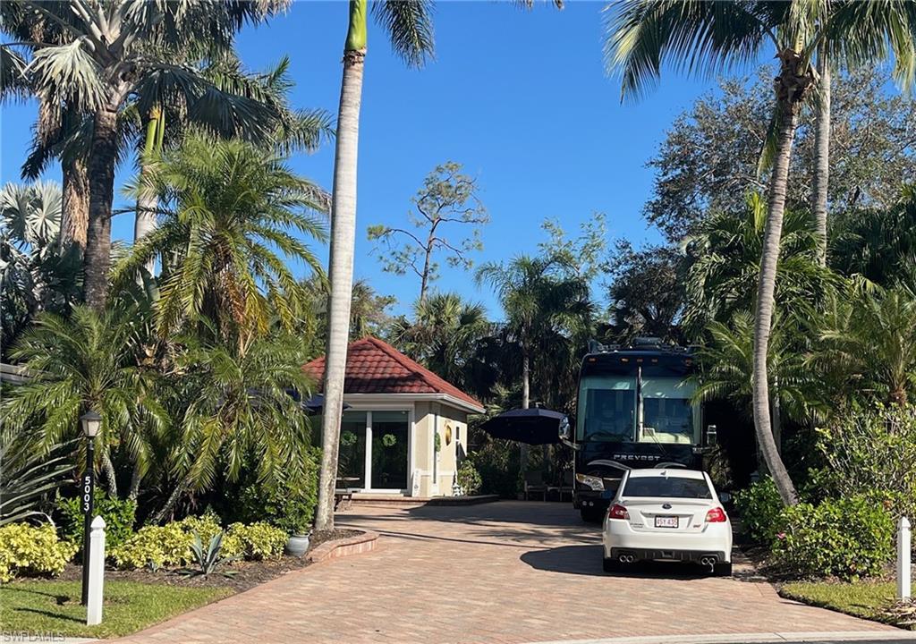 5003 Coach Lane Naples, FL 34114 - Photo 3 of 17 a car parked in front of a house with a tree
