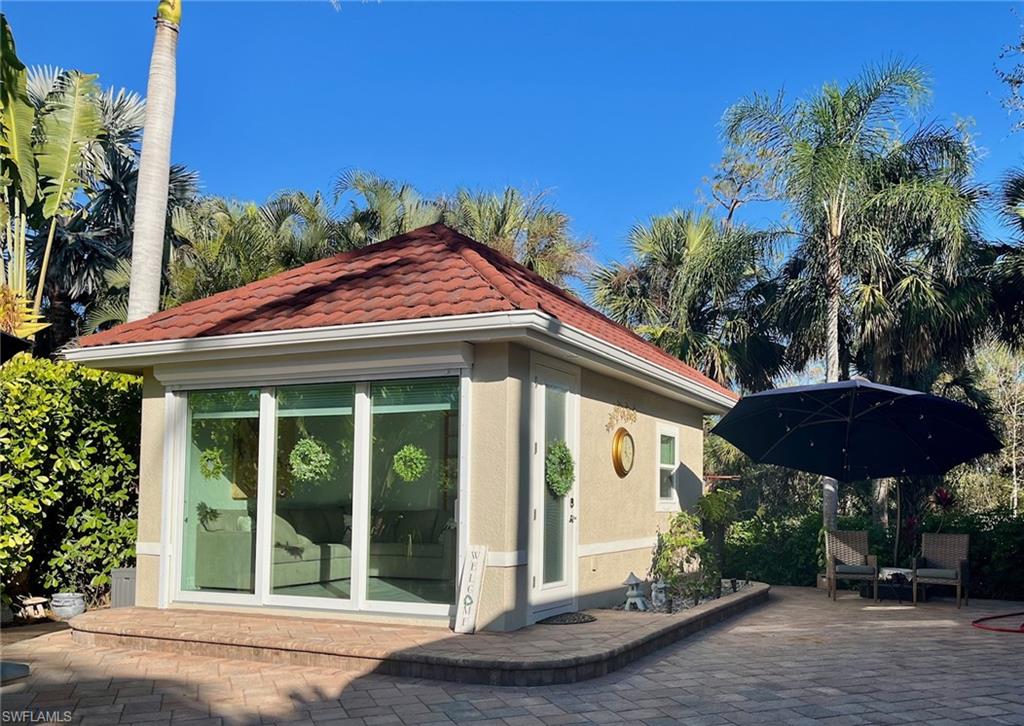 5003 Coach Lane Naples, FL 34114 - Photo 5 of 17 a front view of a house with a yard