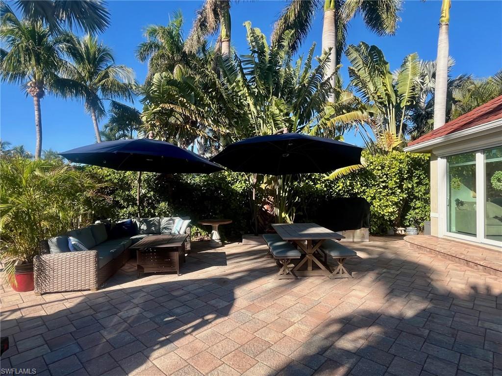 5003 Coach Lane Naples, FL 34114 - Photo 6 of 17 a view of backyard with outdoor seating and trees