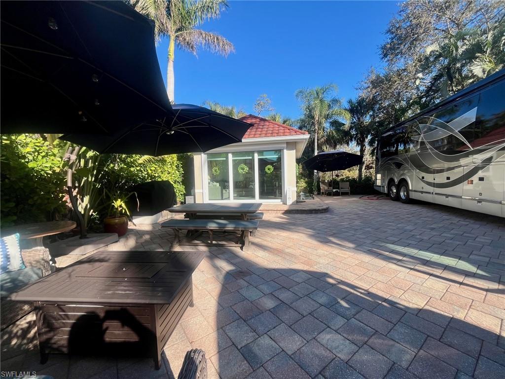 5003 Coach Lane Naples, FL 34114 - Photo 7 of 17 a view of a backyard with sitting area and furniture
