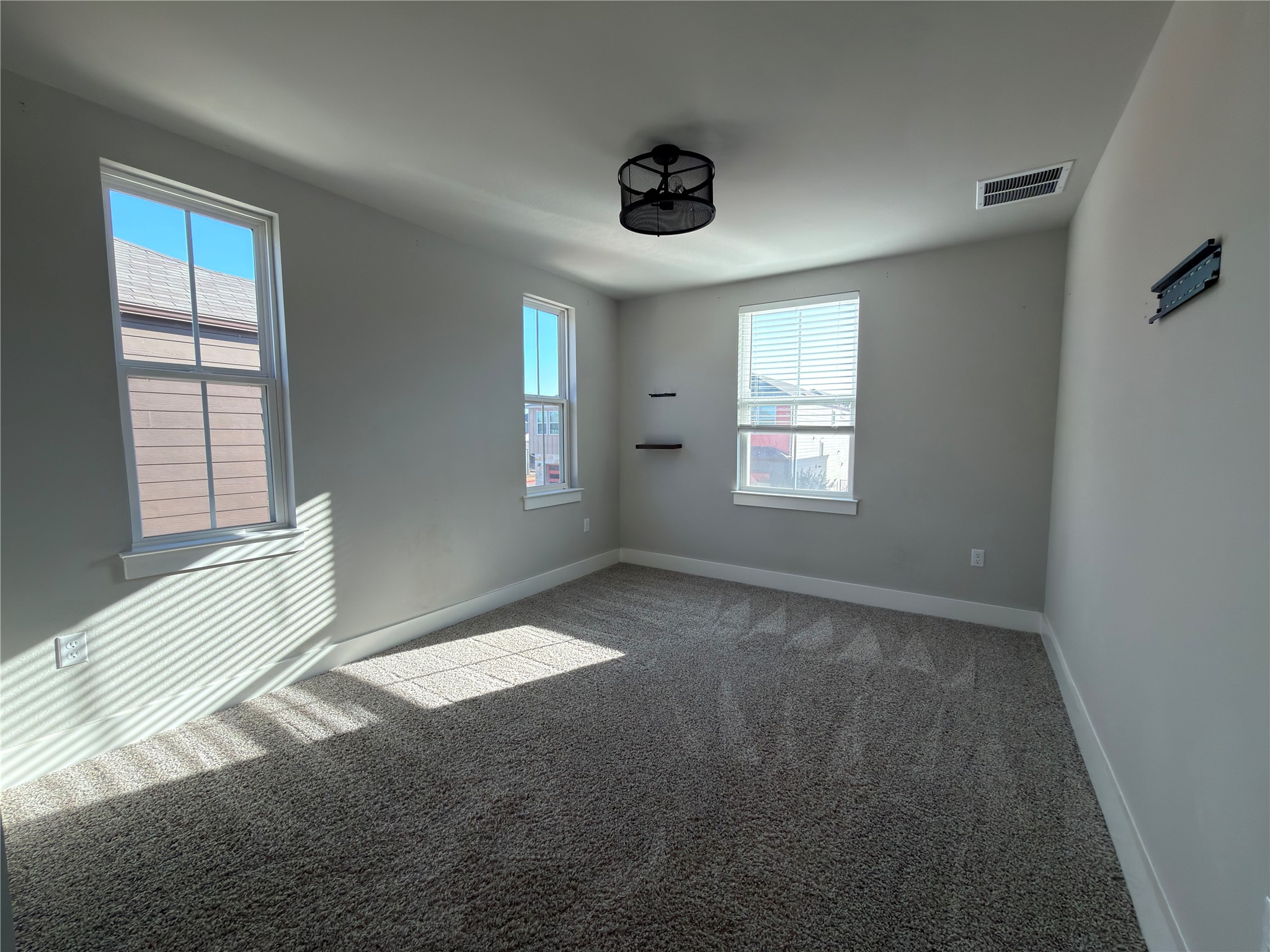 7312 Acela Trail Austin, TX 78744 - Photo 16 of 26 Unfurnished room with carpet and healthy amount of natural light