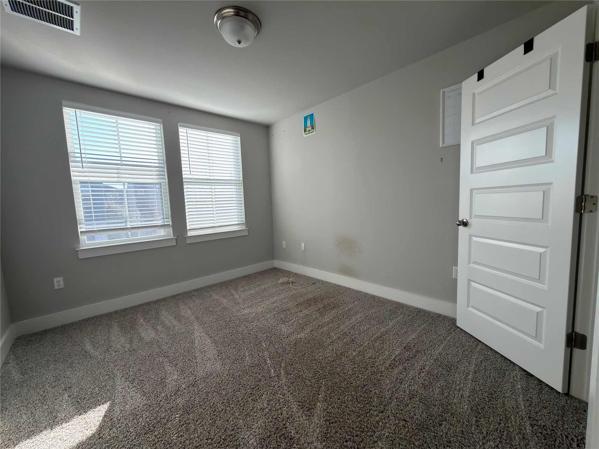 7312 Acela Trail Austin, TX 78744 - Photo 18 of 26 Spare room with baseboards and carpet floors