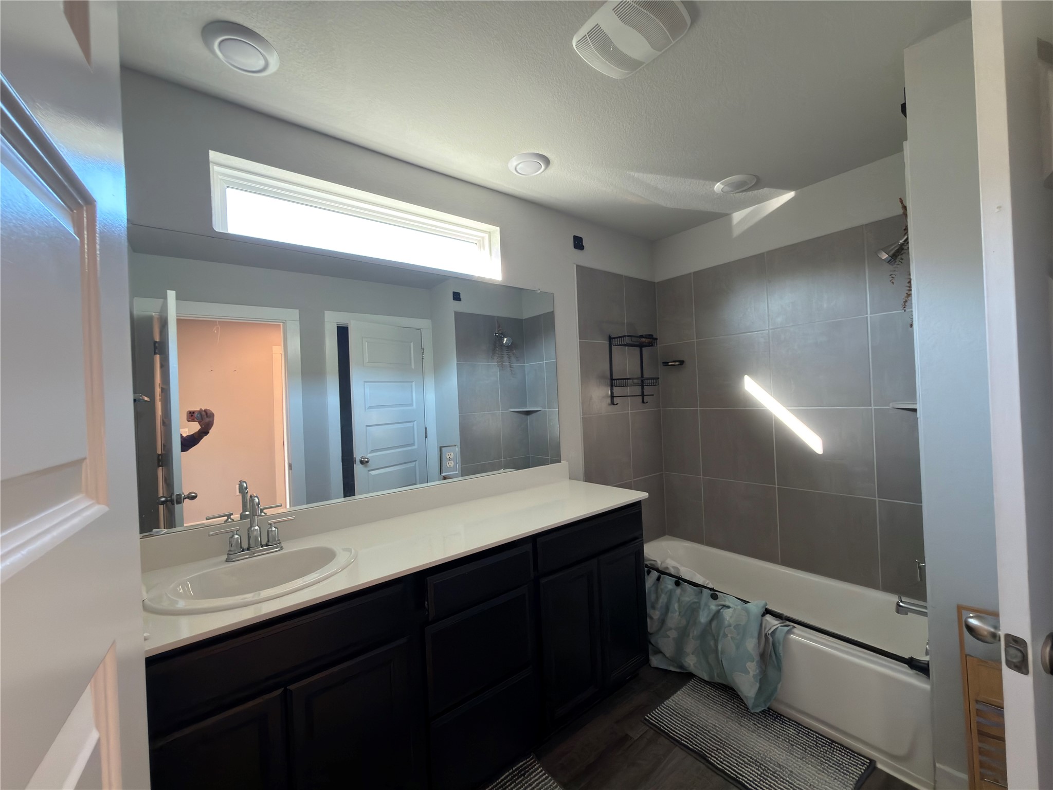 7312 Acela Trail Austin, TX 78744 - Photo 19 of 26 Bathroom with bathtub / shower combination, vanity, and dark wood-type flooring