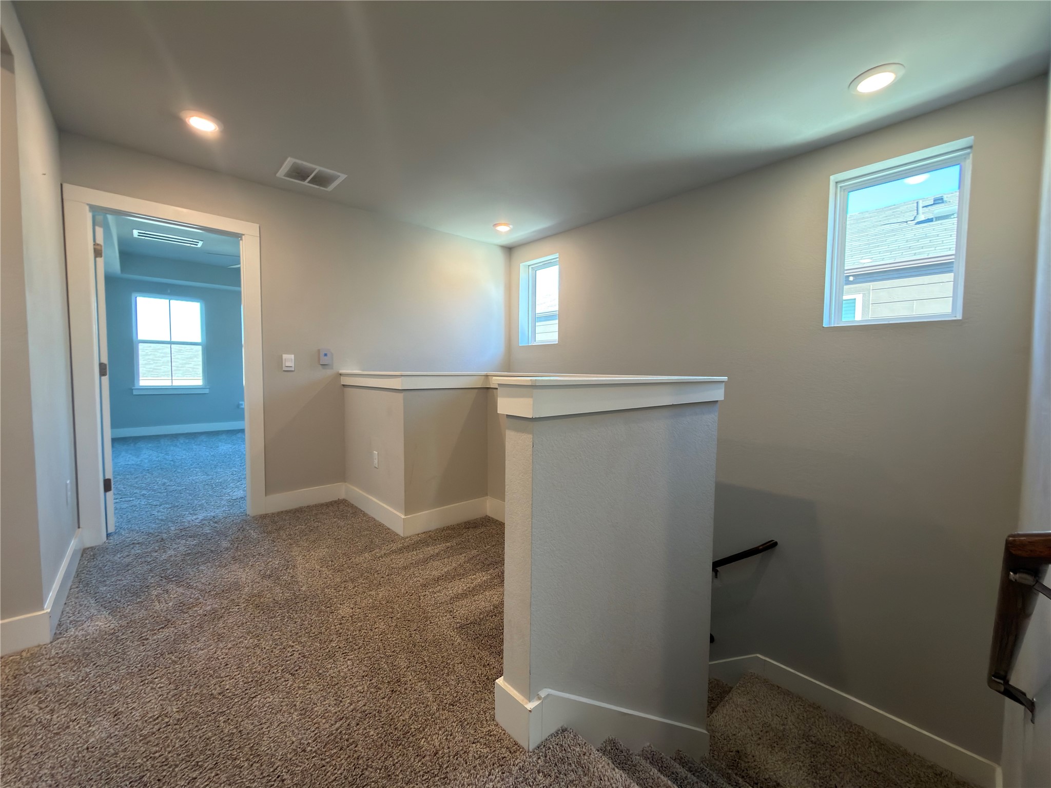 7312 Acela Trail Austin, TX 78744 - Photo 20 of 26 Corridor featuring an upstairs landing, carpet floors, healthy amount of natural light, and recessed lighting