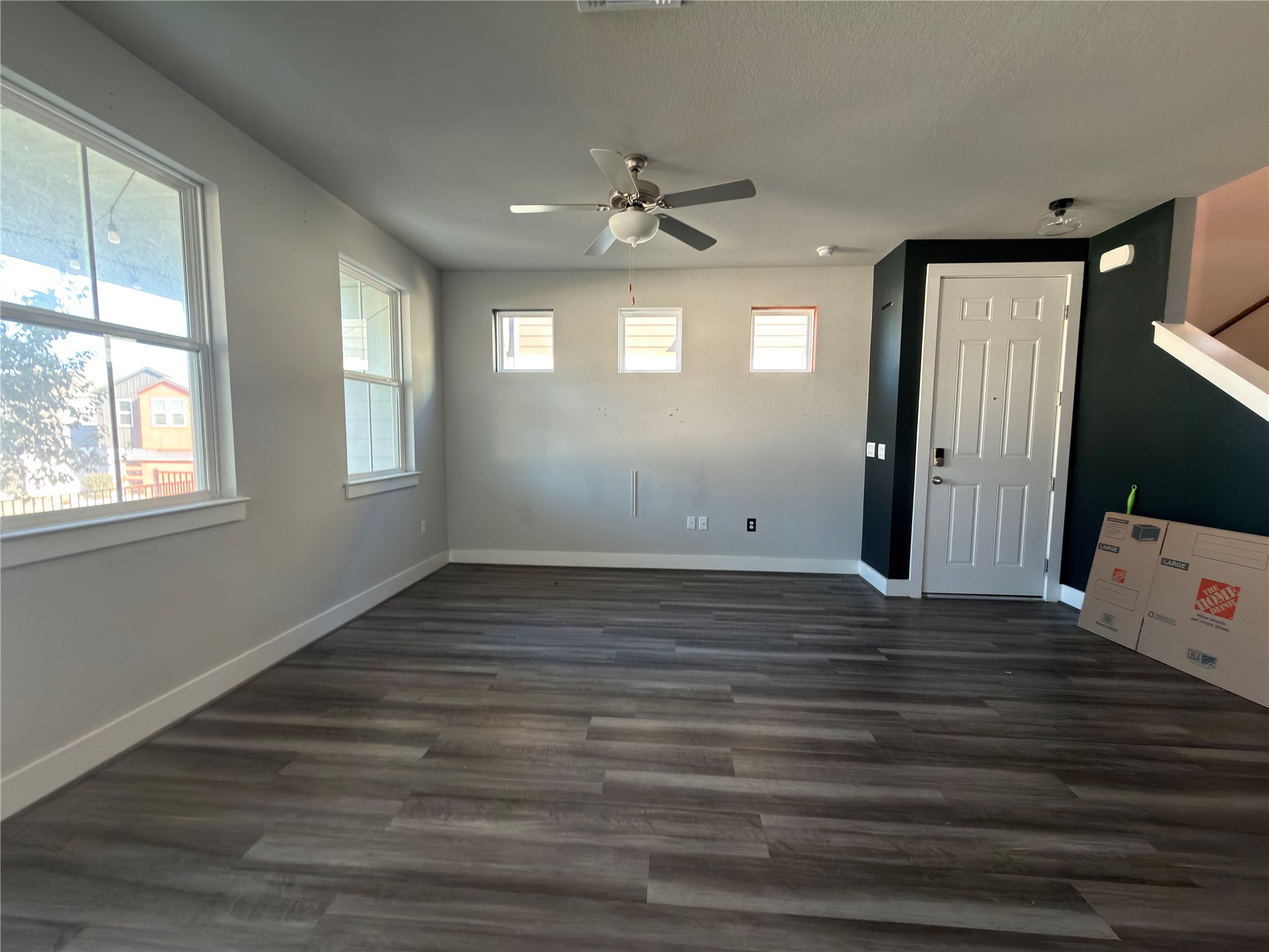 7312 Acela Trail Austin, TX 78744 - Photo 3 of 26 Unfurnished room with a ceiling fan and dark wood-style floors