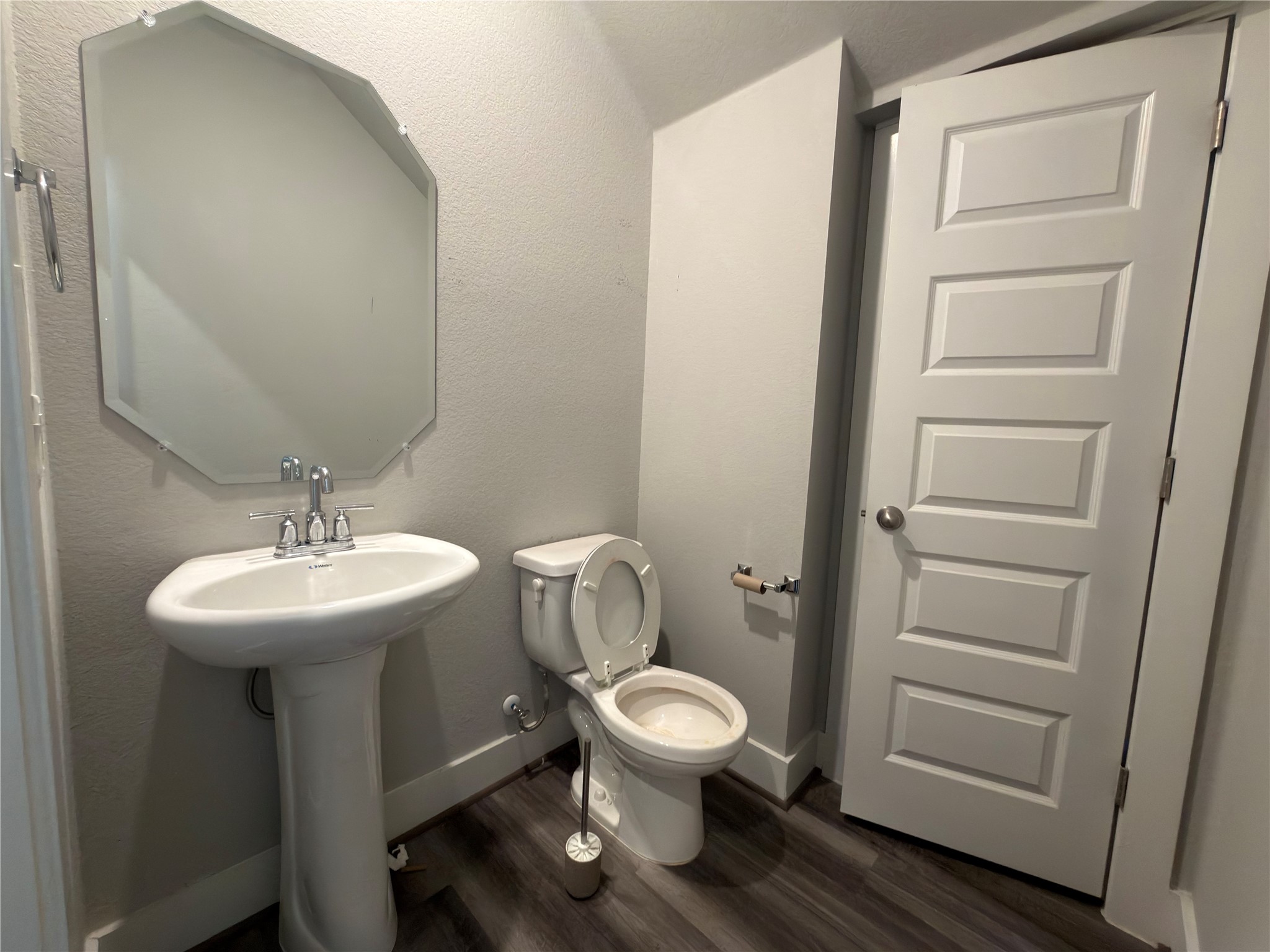 7312 Acela Trail Austin, TX 78744 - Photo 8 of 26 Half bath featuring dark wood-type flooring and a textured wall