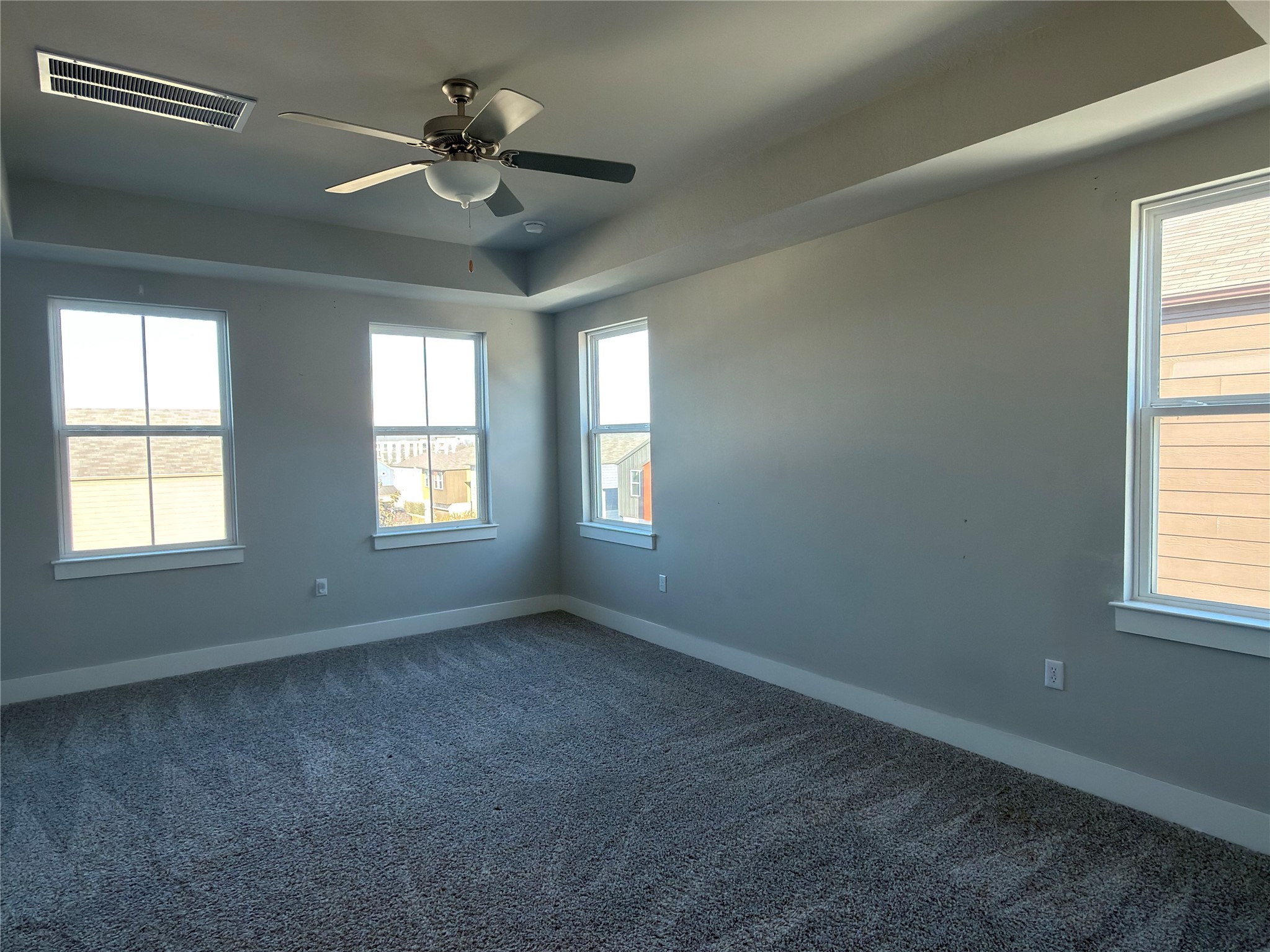 7312 Acela Trail Austin, TX 78744 - Photo 9 of 26 Unfurnished room with ceiling fan and dark carpet