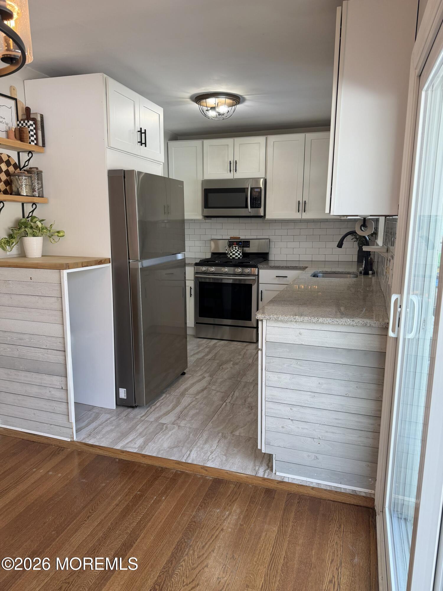 43 Lake Drive Howell, NJ 07731 - Photo 17 of 22 a kitchen with a refrigerator an oven and cabinets