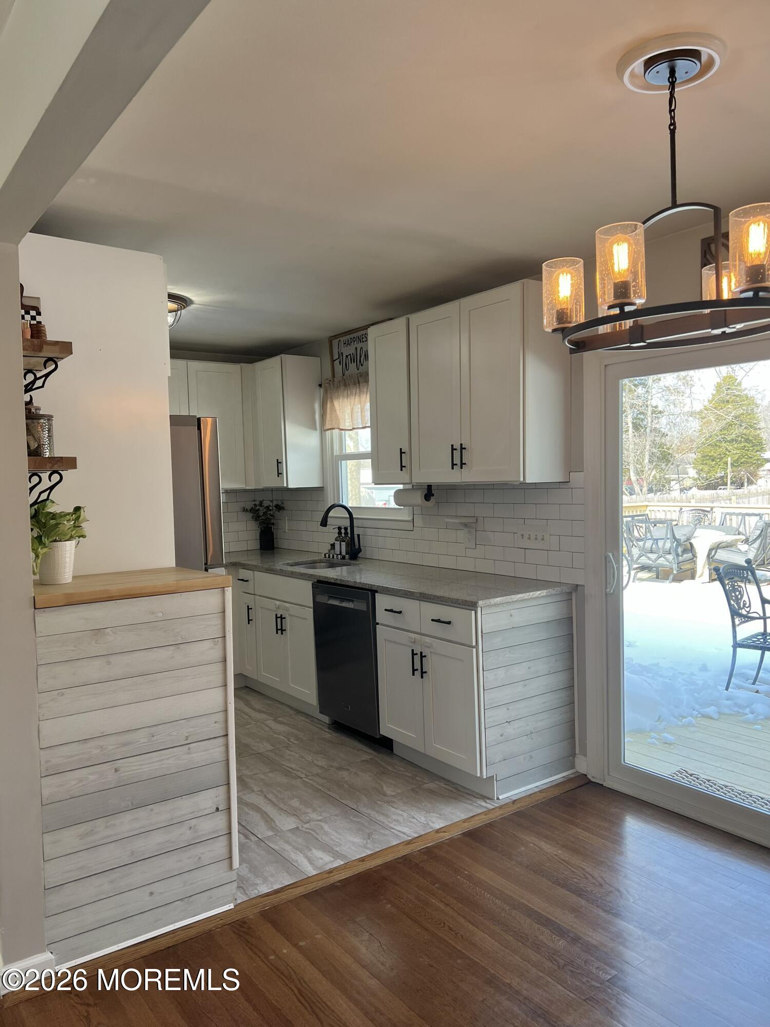 43 Lake Drive Howell, NJ 07731 - Photo 18 of 22 a kitchen with stainless steel appliances granite countertop a stove a sink and a refrigerator
