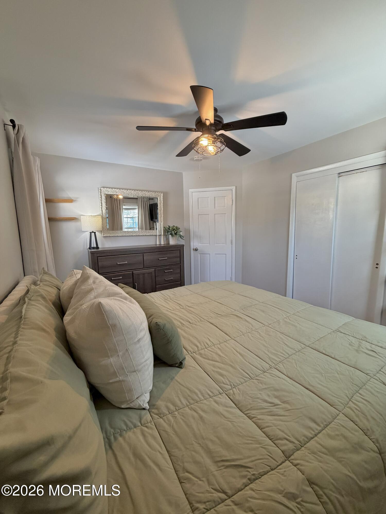 43 Lake Drive Howell, NJ 07731 - Photo 8 of 22 a bedroom with a large bed and a ceiling fan