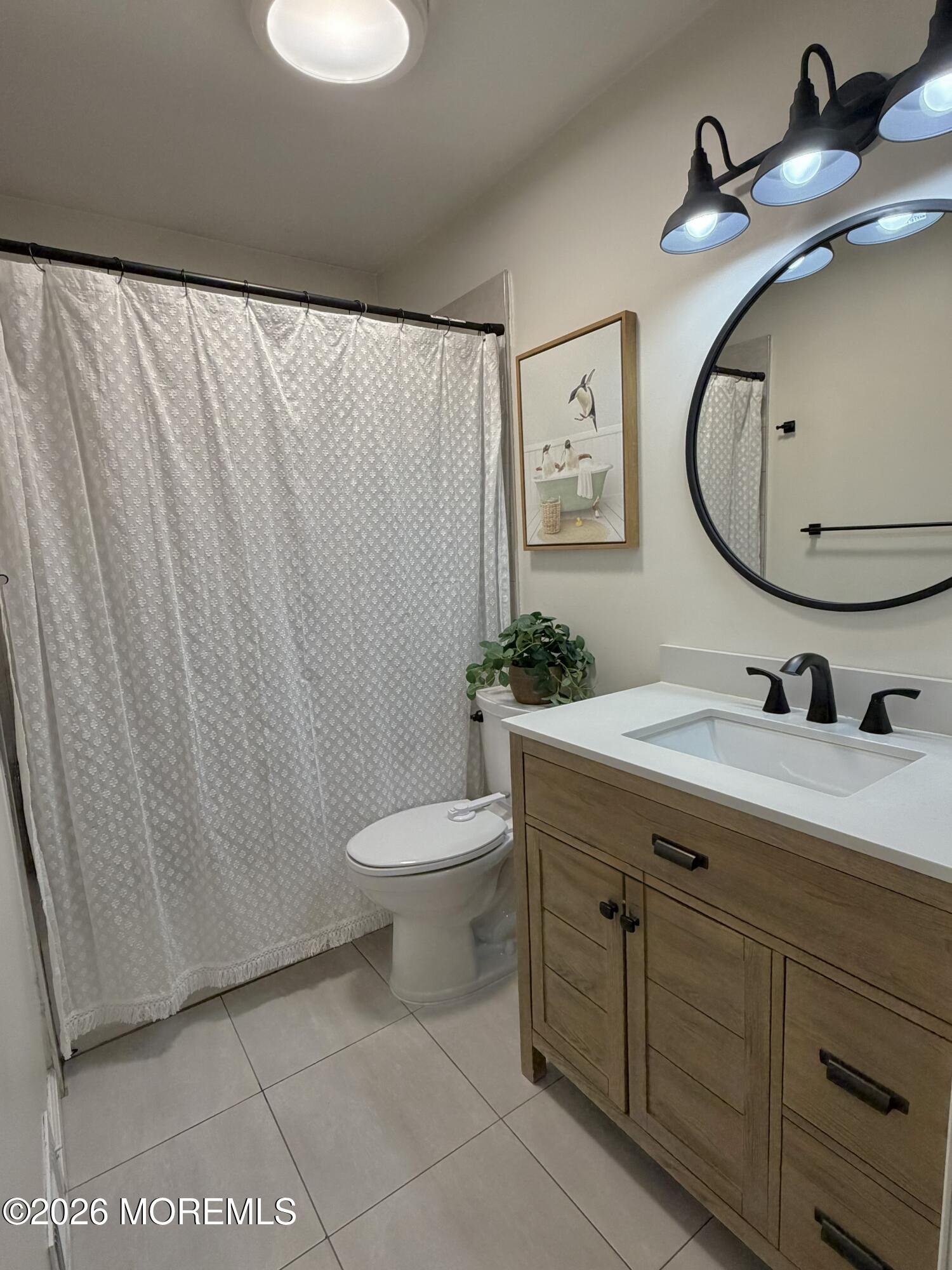 43 Lake Drive Howell, NJ 07731 - Photo 10 of 22 a bathroom with a sink and a mirror