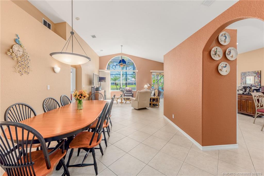 2032 Northwest Marsh Rabbit Lane Stuart, FL 34994 - Photo 14 of 30 a dining room with furniture and a floor to ceiling window