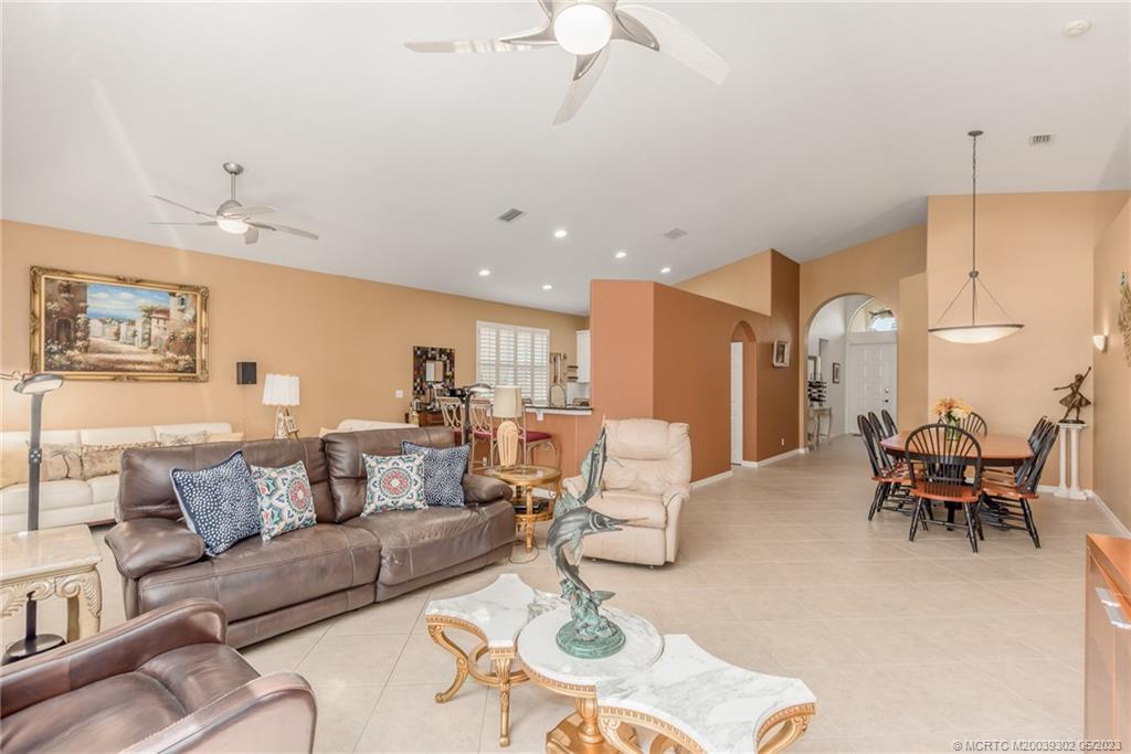 2032 Northwest Marsh Rabbit Lane Stuart, FL 34994 - Photo 16 of 30 a living room with furniture kitchen view and a chandelier