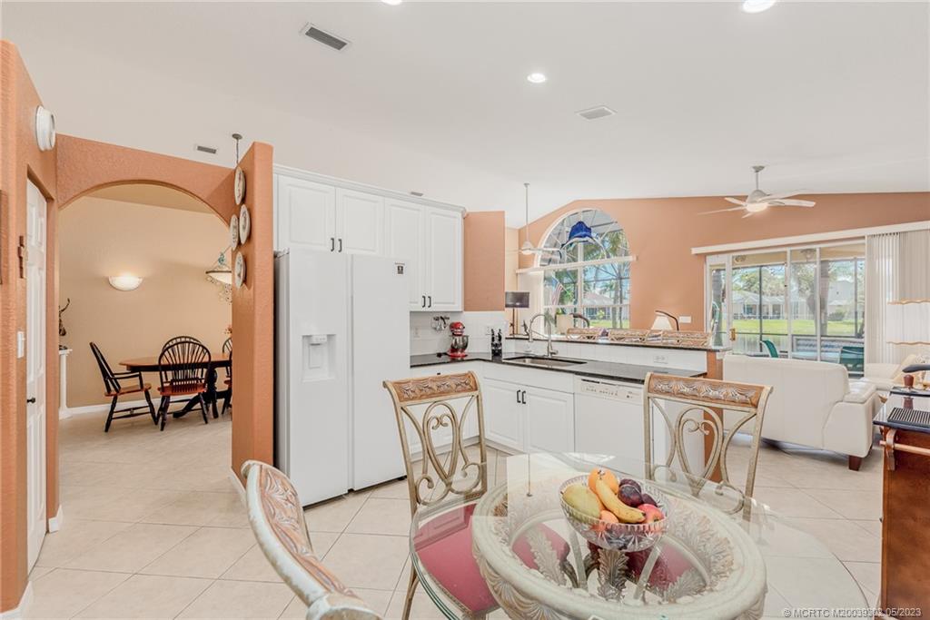 2032 Northwest Marsh Rabbit Lane Stuart, FL 34994 - Photo 18 of 30 a large kitchen with a table and chairs