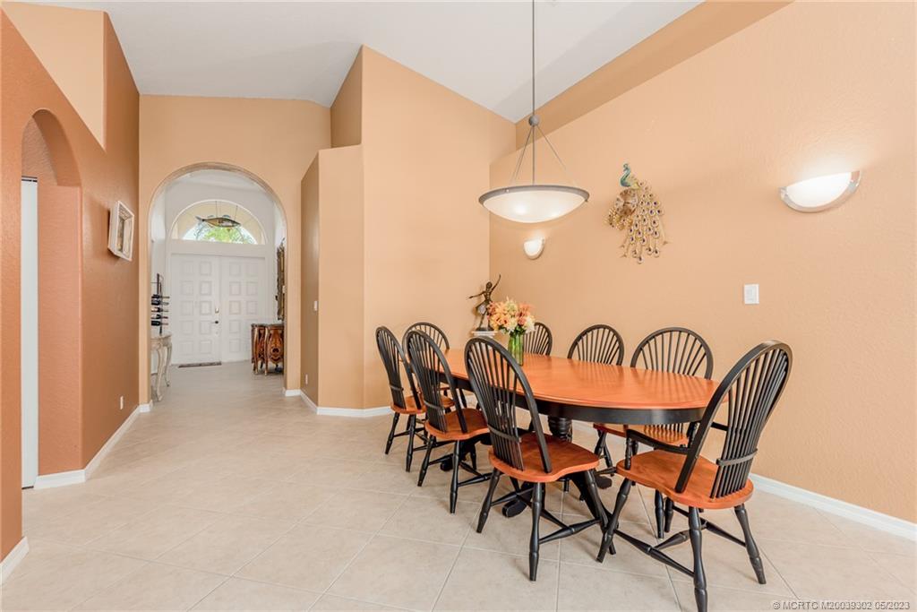 2032 Northwest Marsh Rabbit Lane Stuart, FL 34994 - Photo 19 of 30 a dining room with furniture and a chandelier
