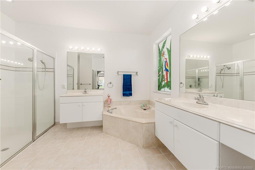 2032 Northwest Marsh Rabbit Lane Stuart, FL 34994 - Photo 21 of 30 a bathroom with a sink a toilet a tub and a mirror