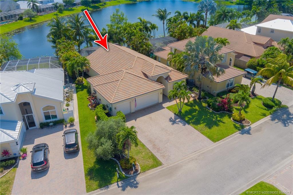 2032 Northwest Marsh Rabbit Lane Stuart, FL 34994 - Photo 28 of 30 an aerial view of a house with a yard and garden