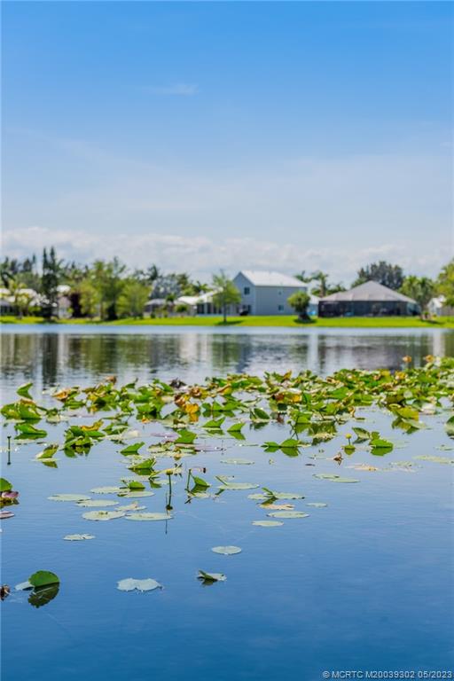 2032 Northwest Marsh Rabbit Lane Stuart, FL 34994 - Photo 29 of 30 a front view of a house with a lake view