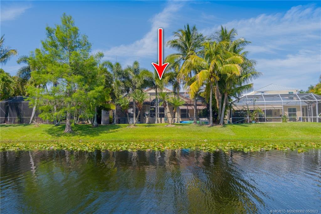 2032 Northwest Marsh Rabbit Lane Stuart, FL 34994 - Photo 6 of 30 a view of a lake with a building in front of it