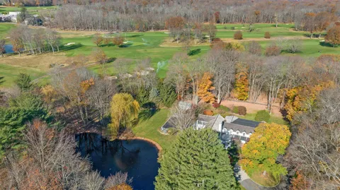 an aerial view of residential house with outdoor space and swimming pool